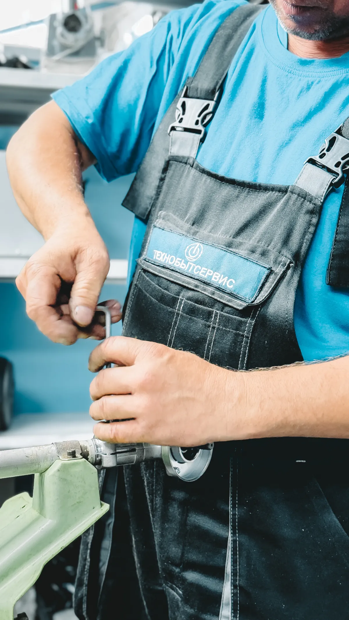 A plumber using a wrench to work on a pipe connection
